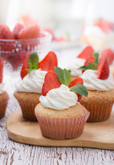 Homemade buttercream cupcakes with strawberries