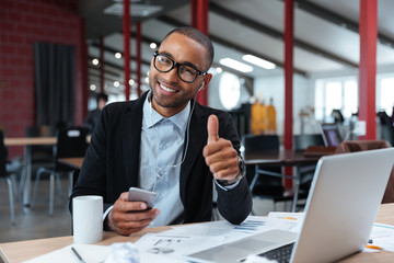 Stylish young businessman showing okay sign