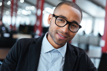 Fototapeta premium Close-up portrait of a smiling businessman in glasses