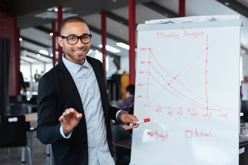 Businessman presenting monthy budget using flipchart