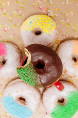 Chocolate glazed donuts and sprinkle donuts.