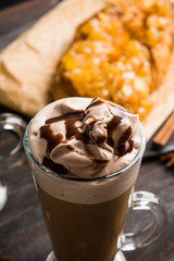 Coffee in glass on the rustic wooden background. Shallow depth of field.