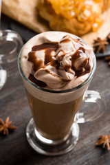 Coffee in glass on the rustic wooden background. Shallow depth of field.
