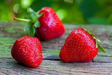 Ripe red strawberries on wooden table 