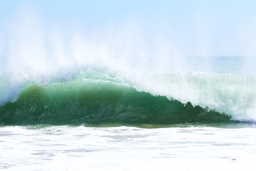Amazing beauty and power of surf waves and fishing boat
