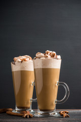 Coffee in glass on the rustic wooden background