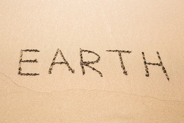 earth text on the sand