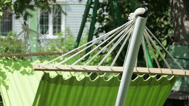 The close-up shot of swaying green hammock