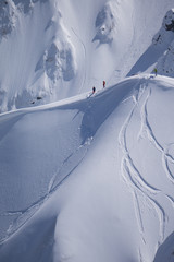 Snowboard freeride, snowboarders and tracks on a mountain slope. Extreme winter sport.