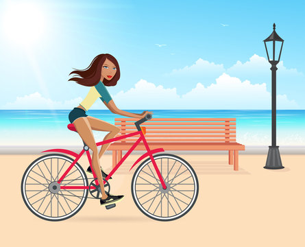 Woman cycling on the beach