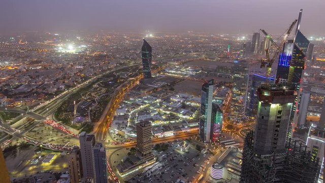 Skyline with Skyscrapers day to night timelapse in Kuwait City downtown illuminated at dusk. Kuwait City, Middle East
