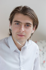Portrait of young man listening to music with smartphone