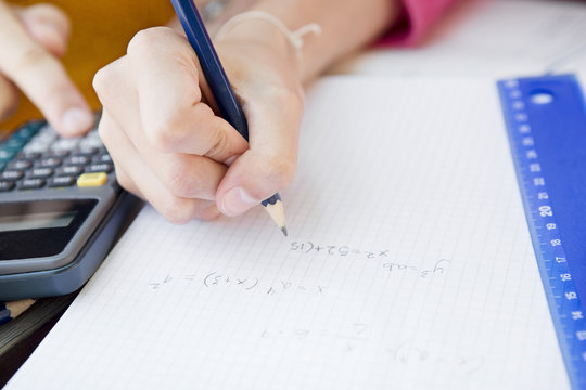 Teenage girls doing maths, close-up