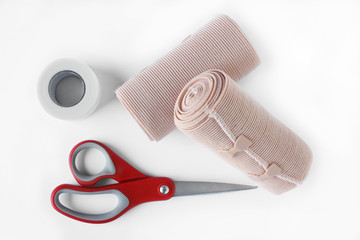 Medical bandage rolls, bandage, elastic , scotch tape, first aid supplies, a white background.