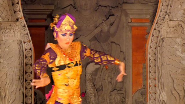 woman dancing on stage performing balinese  barong dance in traditional costume model release signed