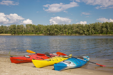 Camping with kayaks on the beach on a sunny day.
