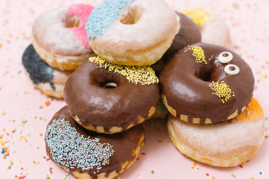 Chocolate glazed donuts and sprinkle donuts.