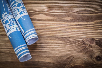 Blue construction drawings on wooden board copy space