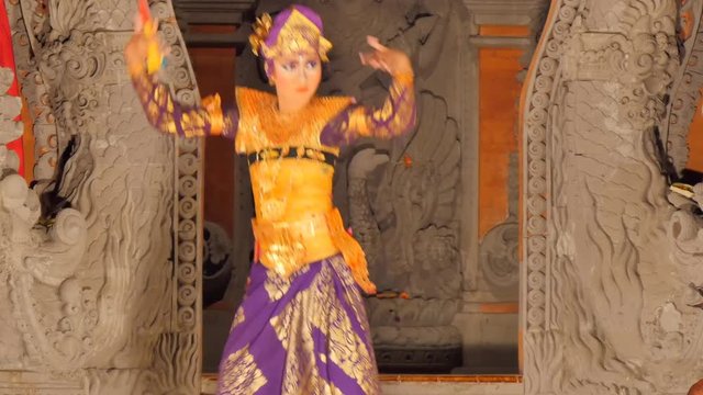 woman dancing on stage performing balinese  barong dance in traditional costume model release signed