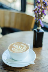Late art coffee on wood table background