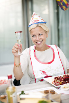 Smiling woman at crayfish party, Stockholm, Sweden