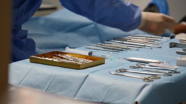 surgical instruments on the table, the doctor takes tools