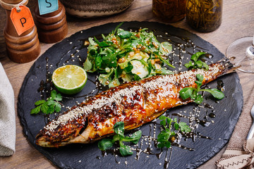 seabass grilled on a plate with vegetables and lemon  for the me