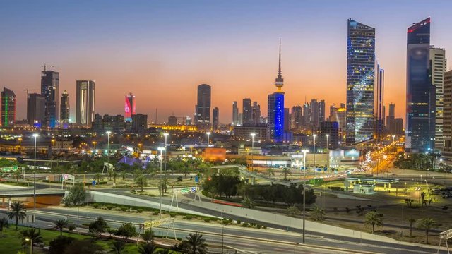 Skyline with Skyscrapers day to night timelapse in Kuwait City downtown illuminated at dusk. Kuwait City, Middle East