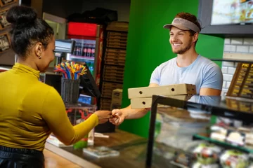 Deurstickers Customer takes his order in a pizzeria. © Nejron Photo