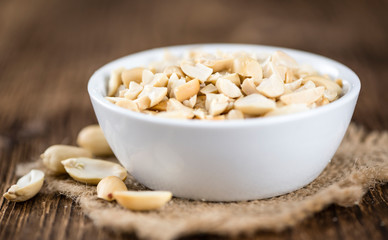 Peanuts (chopped; close-up shot; selective focus)