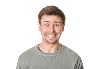 Fototapeta premium Happy young man with manic expression, on gray background