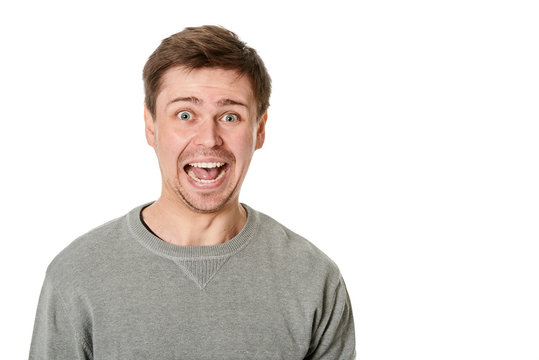 Happy Young Man With Manic Expression, On Gray Background