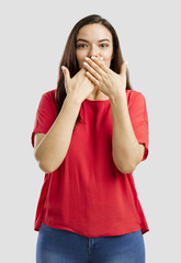 Lovely woman with hands on mouth