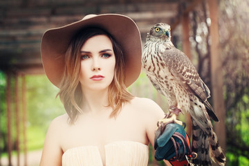 Glamorous Lady in Vintage Hat with Bird