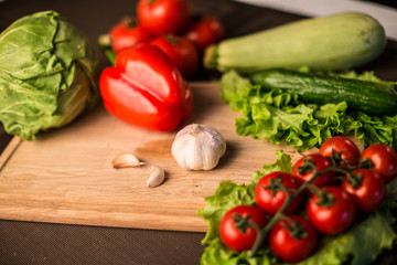 Garlic and fresh salad vegetables on the table