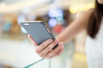 Woman sending sms on mobile phone