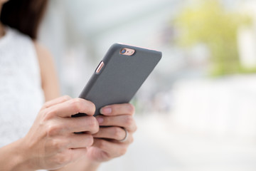 Woman sending message on mobile phone