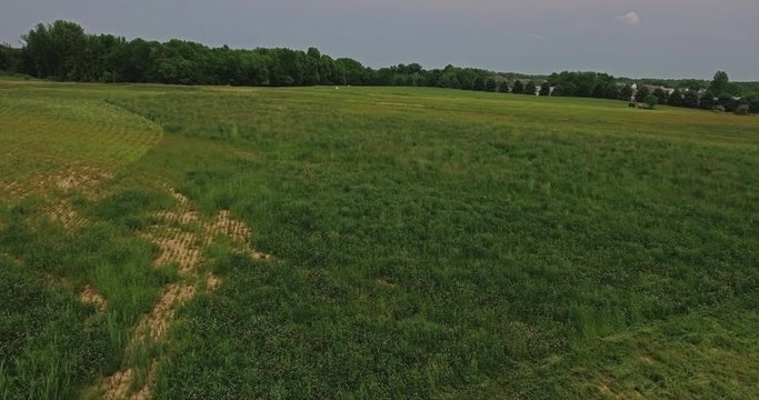 A daytime aerial view of a wide open Ohio field.  	