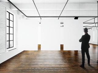 Businessman Modern art museum expo loft interior.Open space studio.Empty white canvas hanging.Wood...