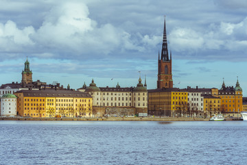 Fototapeta premium Panorama of the center of Stockholm, Gamla Stan, with water in the foreground