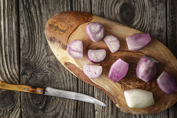 Sliced shallot on the wooden board  top view