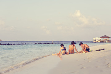 mother with two children girl and boy relaxes on a beach