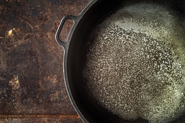Pan with melted butter on the metal background top view