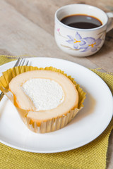 Vanilla roll cake and coffee cup with smartphone, in morning time