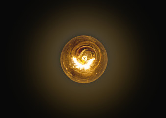 light bulb lit on a black background