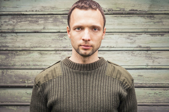 Young Caucasian Man In Military Green Sweater