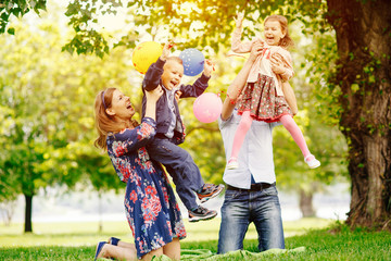 Young happy family having fun in the park