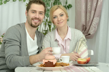 couple at table with coffee and food