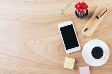 Desktop with smartphone and stationery