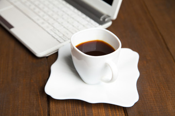 Close-up of black coffee near laptop keyboard